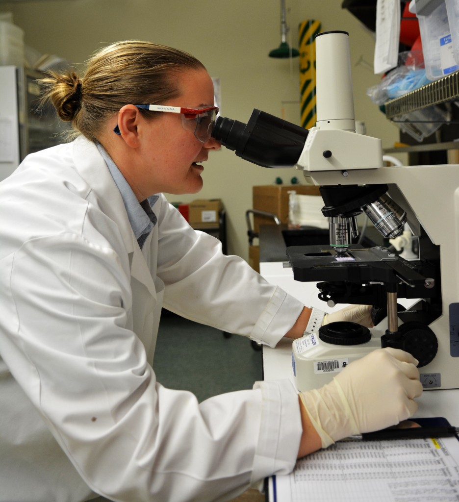 Dr. Snow using a microscope